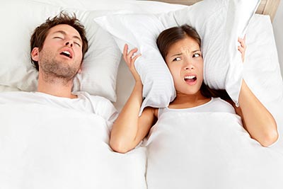 woman lying awake from her husband's sleep apnea